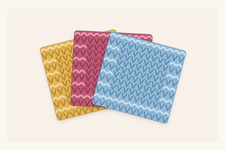 A stack of three knitted dishcloths in three different colors